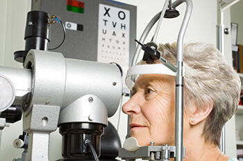 Elderly woman taking an eye exam