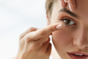 woman putting in contact lens
