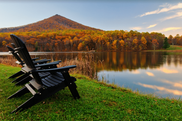 Fall colors with outdoor chairs by a lake